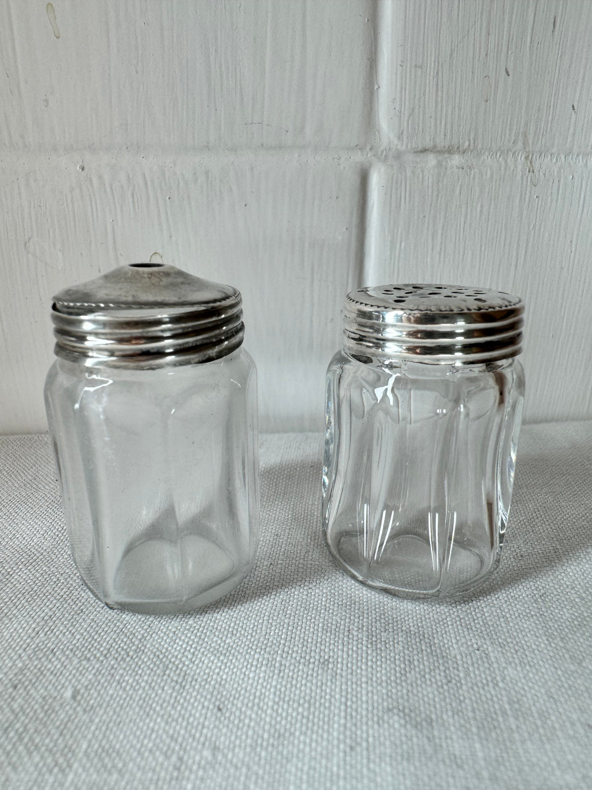 Pair of antique/vintage sterling silver topped salt and pepper pots with faceted glass